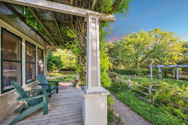 Side porch off of the primary bedroom overlooking the rose garden. | Image 26