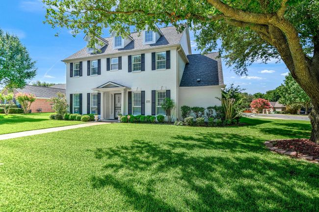Colonial-style house with a front lawn and roof with shingles | Image 35