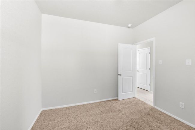 Spare room featuring light carpet and baseboards | Image 25