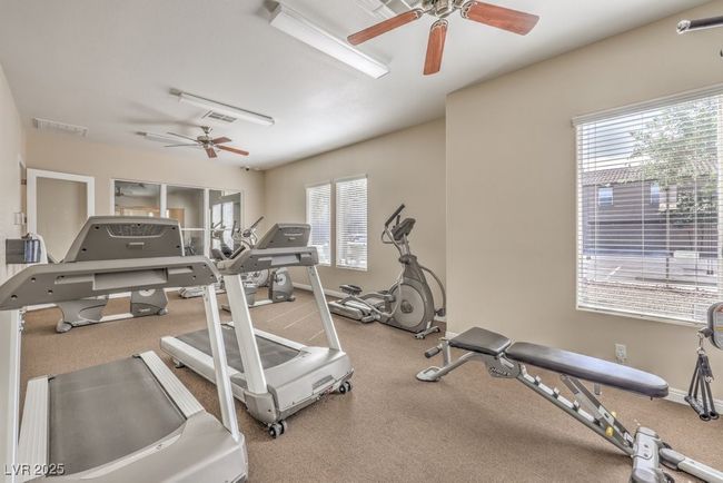 Exercise room with baseboards, a ceiling fan, and plenty of natural light | Image 36