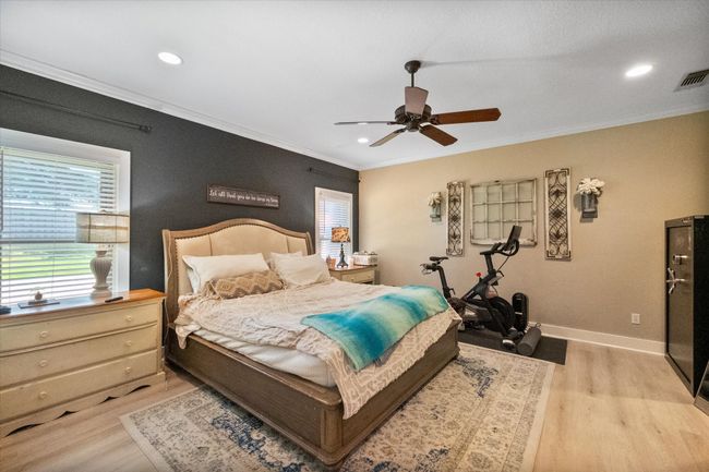 Bedroom with light wood-type flooring, crown molding, baseboards, recessed lighting, and ceiling fan | Image 14