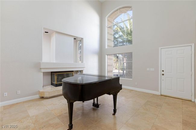 Entryway with a towering ceiling and baseboards | Image 4