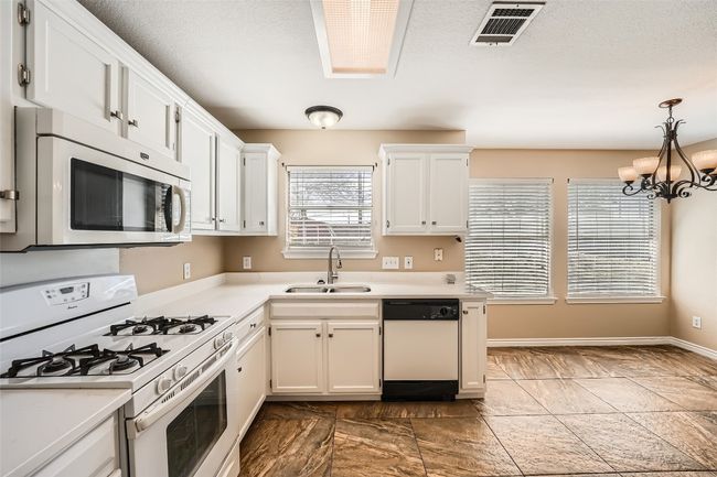 kitchen with white cabinetry and white appliances | Image 4