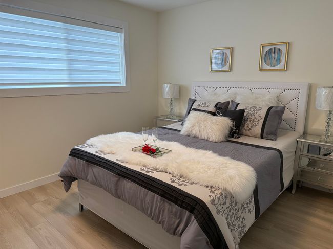 Bedroom featuring wood finished floors and baseboards | Image 11