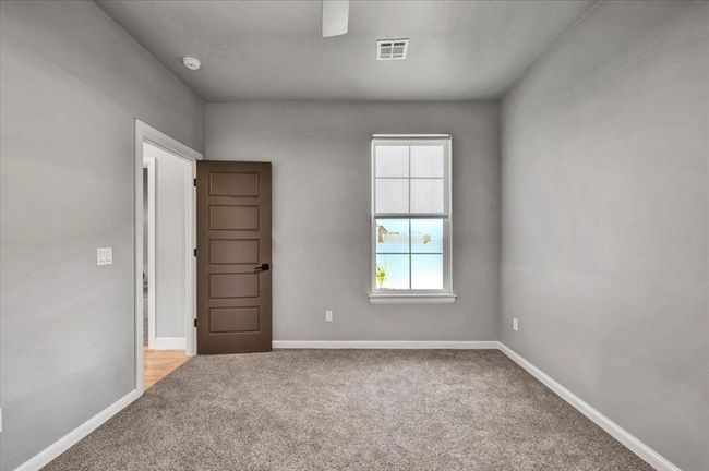 Spare room featuring carpet floors, baseboards, and a smoke detector | Image 46