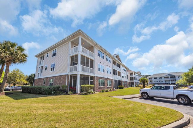 View of building exterior featuring uncovered parking | Image 27