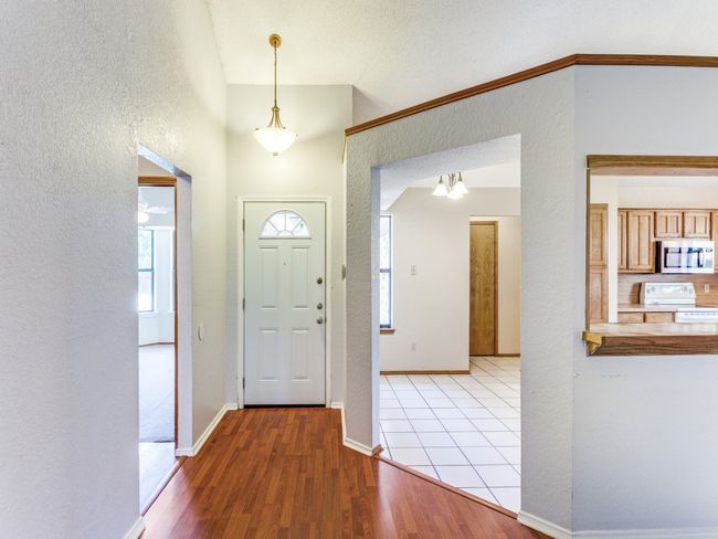 Entryway featuring a textured wall and wood finished floors | Image 25