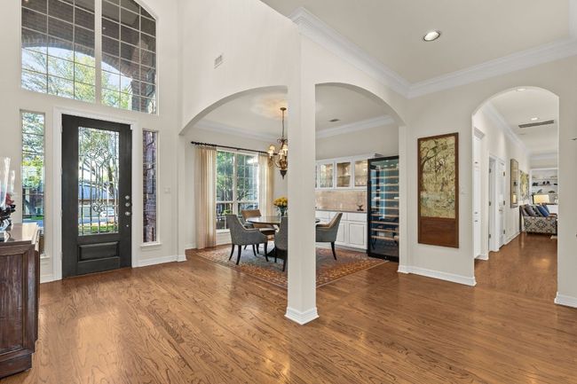 Entrance foyer and formal dining featuring crown molding, lots of natural light and beautiful wood floors. This room opens to the living room. (not in photo) | Image 11