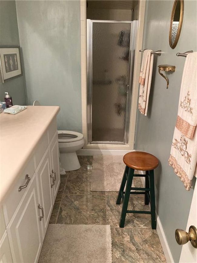 Bathroom featuring vanity, toilet, and a shower with shower door | Image 19