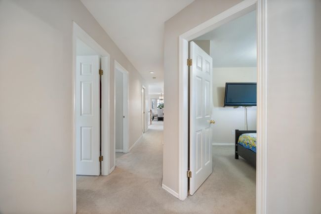 Corridor featuring baseboards and light carpet | Image 30