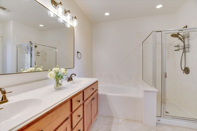 Bathroom featuring a stall shower, double vanity, a garden tub, and recessed lighting | Image 14