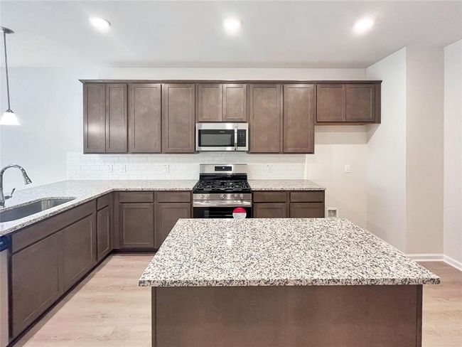 The Cardinal II- Kitchen with added Island. Home under construction. Sample floor plan photo used for illustrative purposes only. Upgrades, selections options, windows and colors may vary. | Image 5