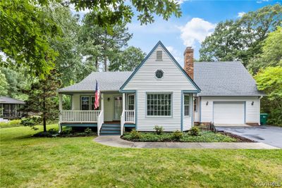 View of front facade with a garage, covered porch, and a front yard | Image 2