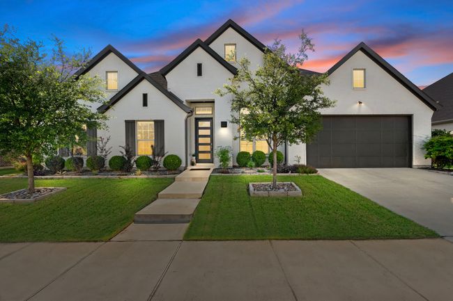 French country home with concrete driveway, a front lawn, and a garage | Image 30