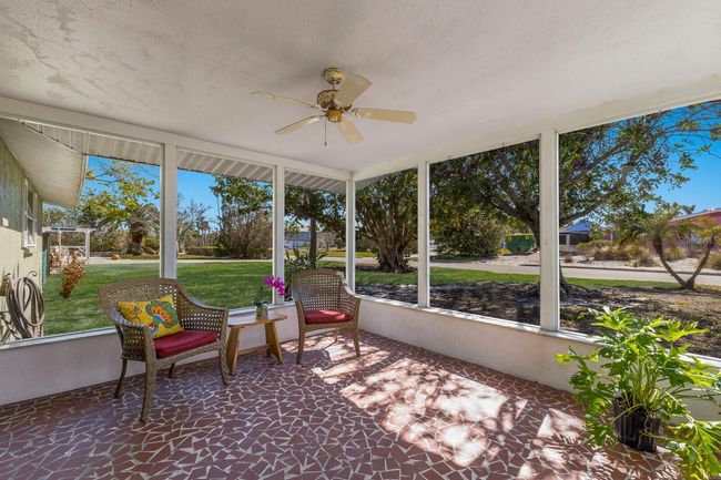 Mature shade trees make this lanai a true Florida retreat. | Image 10