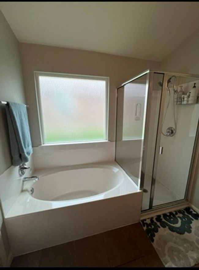 Bathroom featuring a garden tub, tile patterned floors, and a stall shower | Image 12