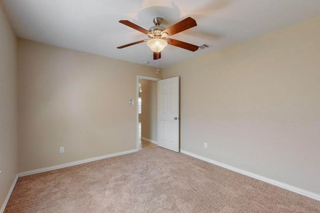 Unfurnished room with visible vents, baseboards, ceiling fan, and light colored carpet | Image 27