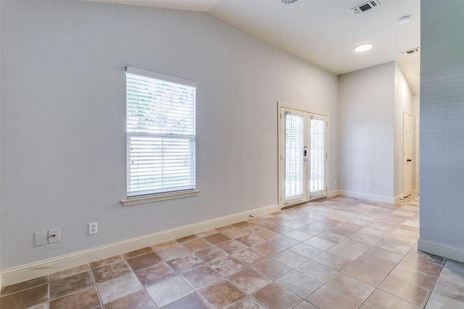 Unfurnished room with french doors, a smoke detector, and vaulted ceiling | Image 14
