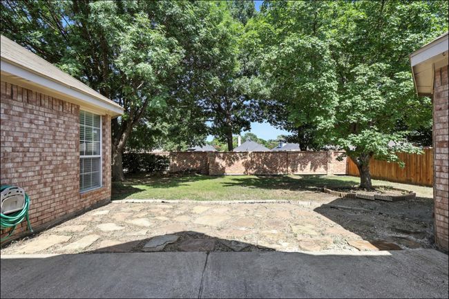 Fenced backyard featuring a patio | Image 39