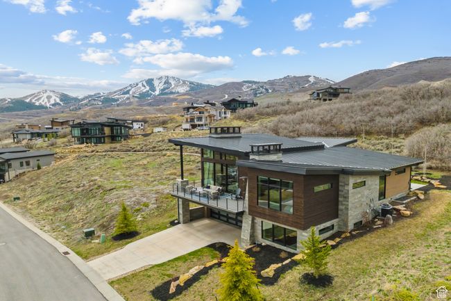 Exterior space with a standing seam roof, concrete driveway, a mountain view, and metal roof | Image 71