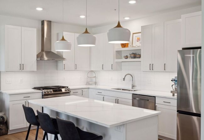 Center island kitchen with top of the line appliances | Image 5