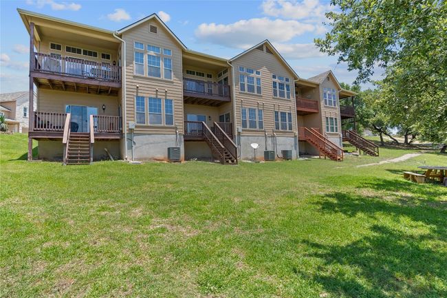 Back of house with central AC, stairway, and a yard | Image 13