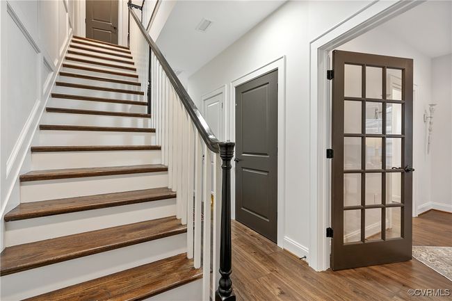 Stairway with visible vents, baseboards, and wood finished floors | Image 36