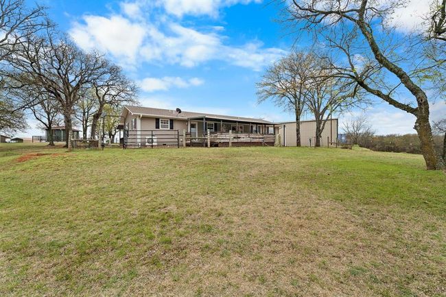 Back of property featuring a wooden deck and a yard | Image 12