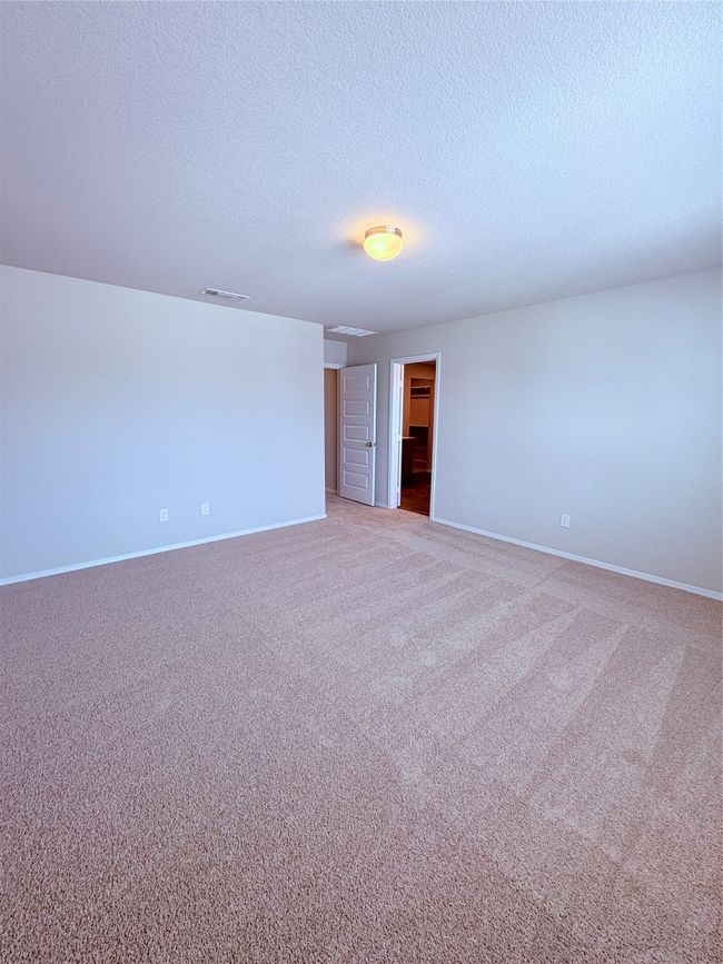 Carpeted spare room with baseboards, a textured ceiling, and visible vents | Image 29