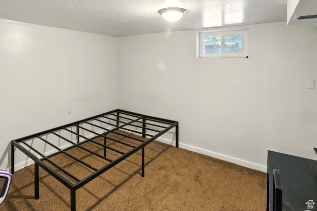 Unfurnished bedroom featuring carpet floors and a textured ceiling | Image 19