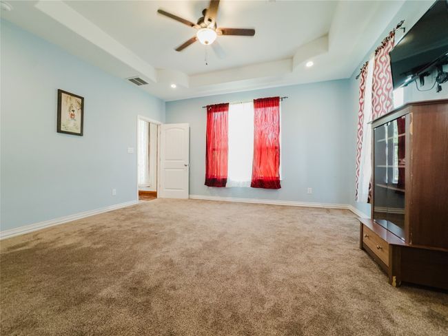 Spare room with carpet floors, a ceiling fan, a tray ceiling, and recessed lighting | Image 23