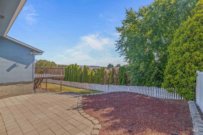Fenced backyard featuring a patio and a wooden deck | Image 40