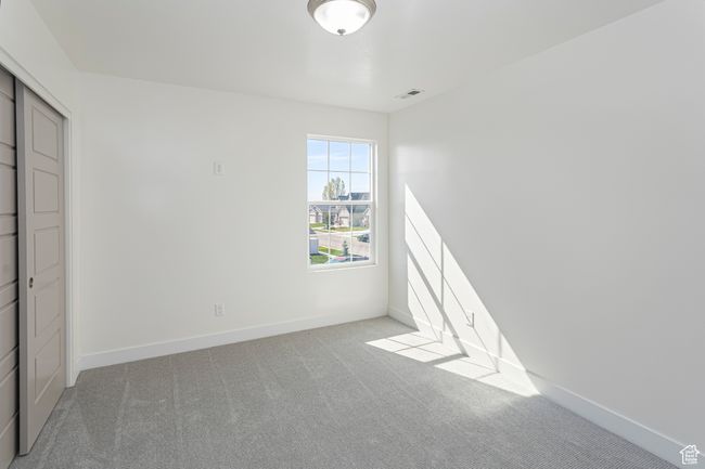 Unfurnished bedroom with visible vents, carpet flooring, and baseboards | Image 25