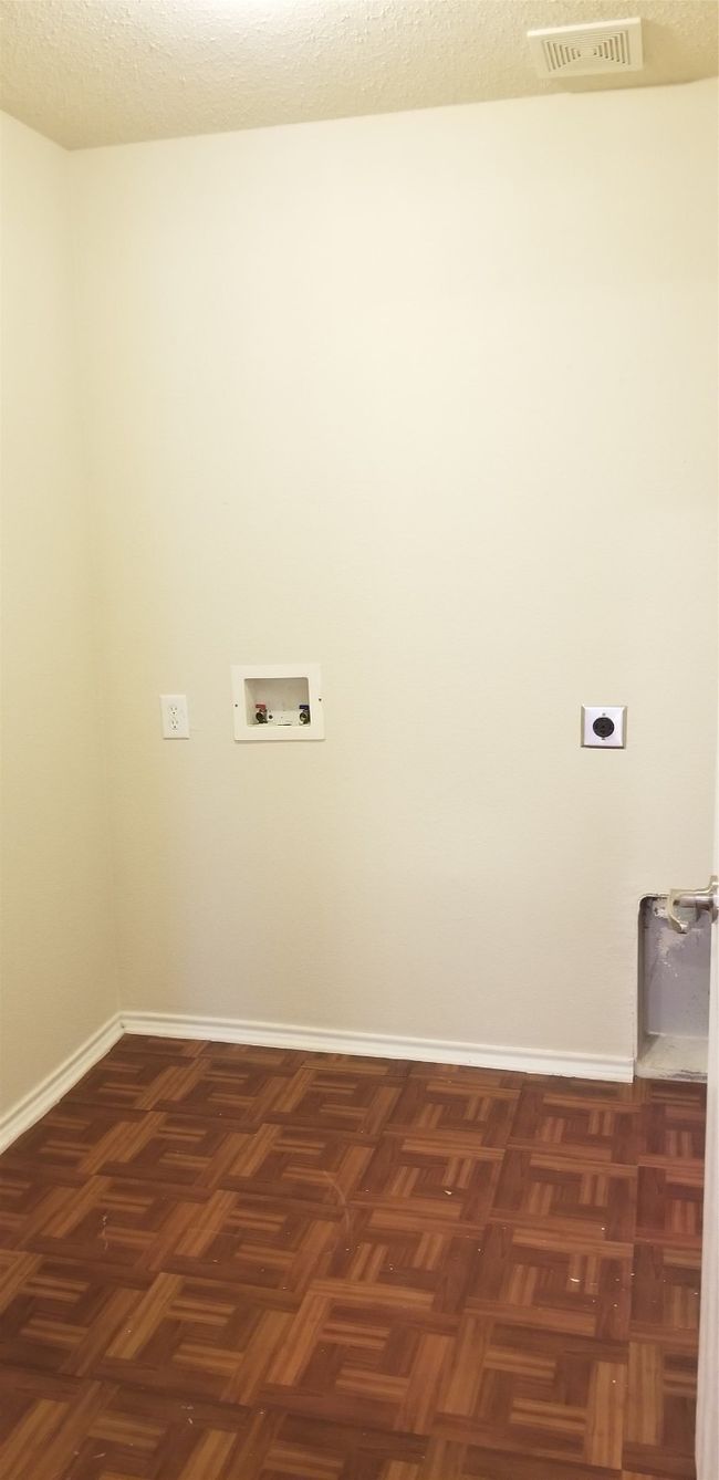 Laundry area featuring electric dryer hookup and hookup for a washing machine | Image 12