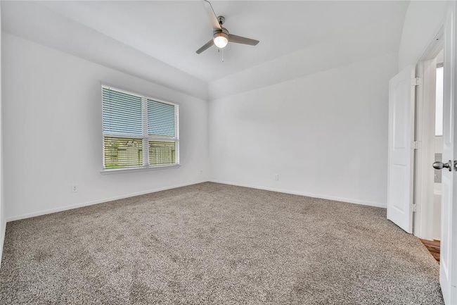 The primary suite boasts vaulted ceilings and double windows overlooking your backyard | Image 26