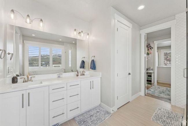 Bathroom featuring wood finished floors, a healthy amount of sunlight, and a sink | Image 14