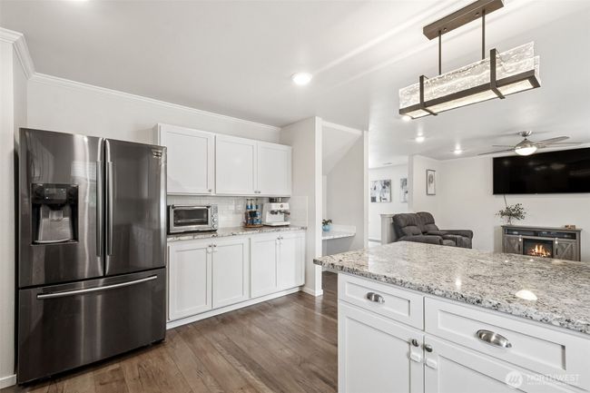 Beautifully remodeled kitchen with stunning quartz countertops and backsplash, upgraded stainless appliances | Image 12
