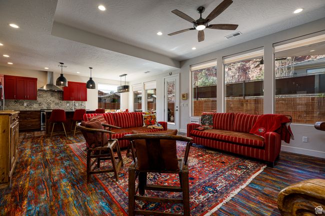 Living area featuring a ceiling fan, a textured ceiling, baseboards, and recessed lighting | Image 11