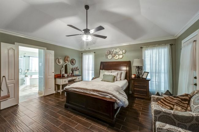Bedroom with ornamental molding, multiple windows, and wood tiled floor | Image 22