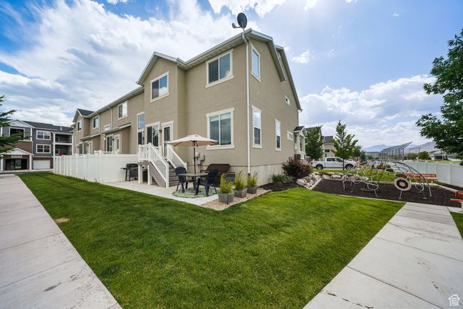 Rear view of property with a patio, a residential view, and stucco siding | Image 31