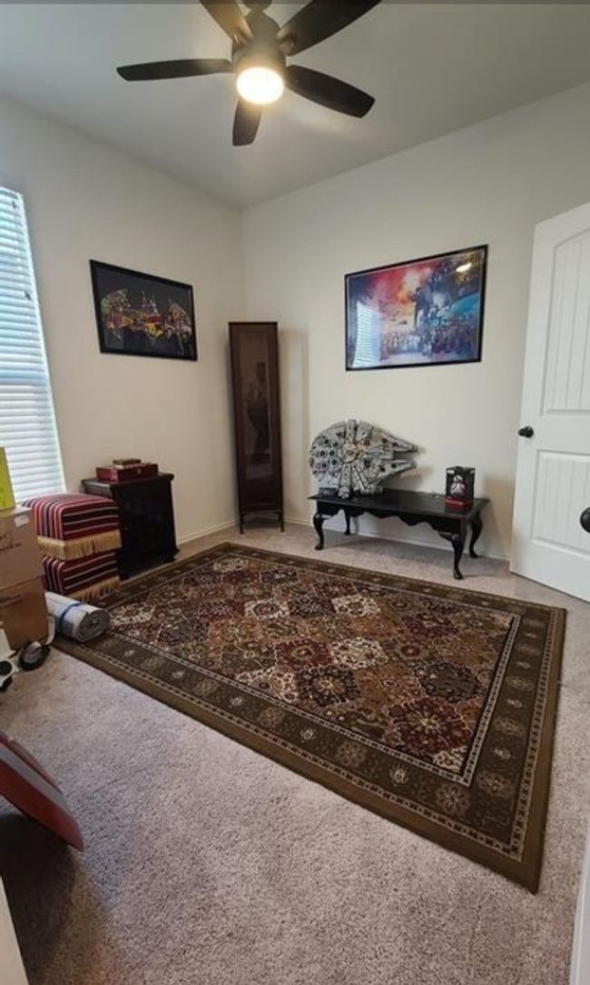 Carpeted living area with ceiling fan | Image 9