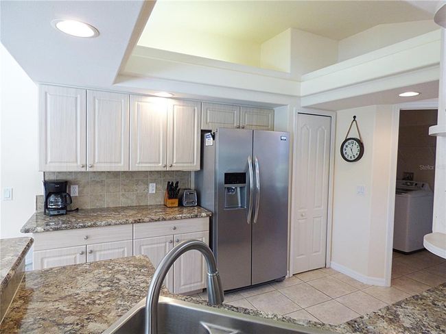 lot of storage including pantry, recessed light plus ceiling light and fan, great flow to Laundry room and garage | Image 25