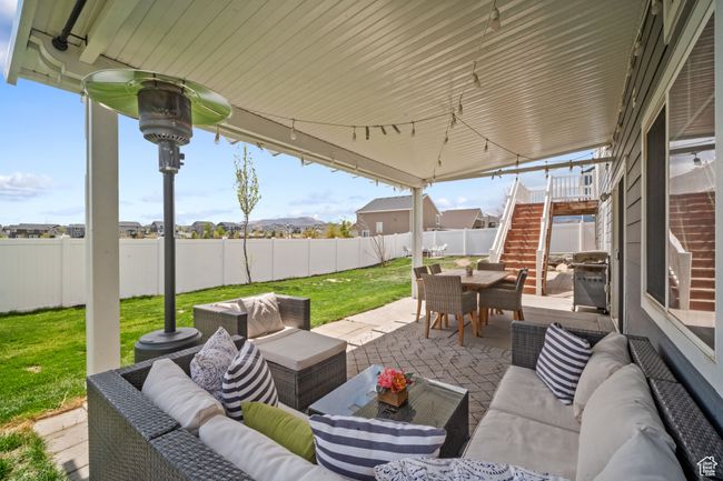View of patio / terrace with an outdoor hangout area, outdoor dining space, stairway, and a fenced backyard | Image 22