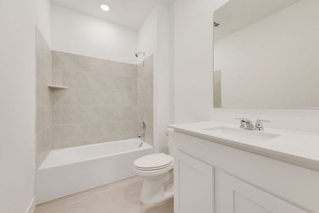 Full bath with vanity, toilet, shower / washtub combination, and wood finished floors | Image 13