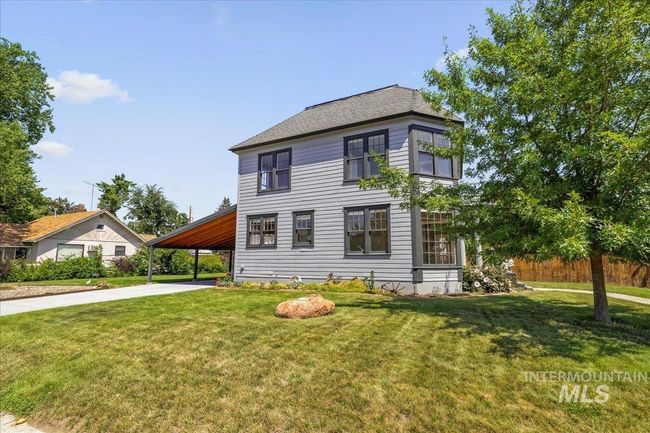 View of front facade featuring an attached carport, a front lawn, and driveway | Image 7