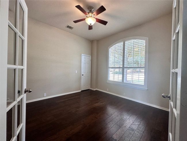 4th Bedroom/study with wood floors, ceiling fan, closet, plantation shutters. | Image 17
