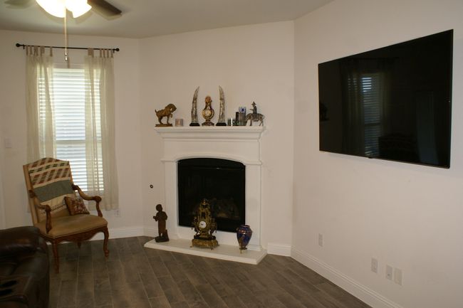 Living room with plenty of natural light, ceiling fan, and wood look tile floors | Image 9