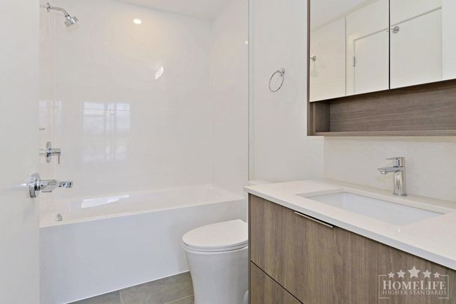 Bathroom featuring tile patterned flooring, toilet, vanity, and bathing tub / shower combination | Image 13
