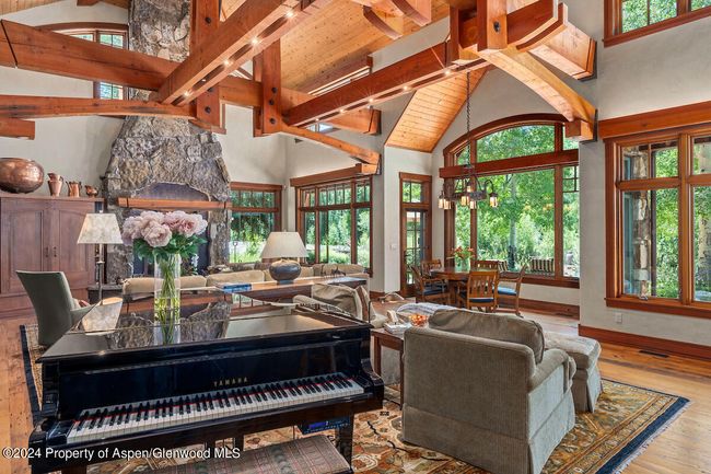 The grand piano, located in the great room where everyone can be entertained, is included in the sale. | Image 12