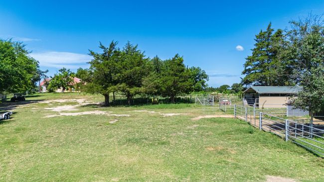 View of yard featuring an outbuilding, an exterior structure, and a pole building | Image 30